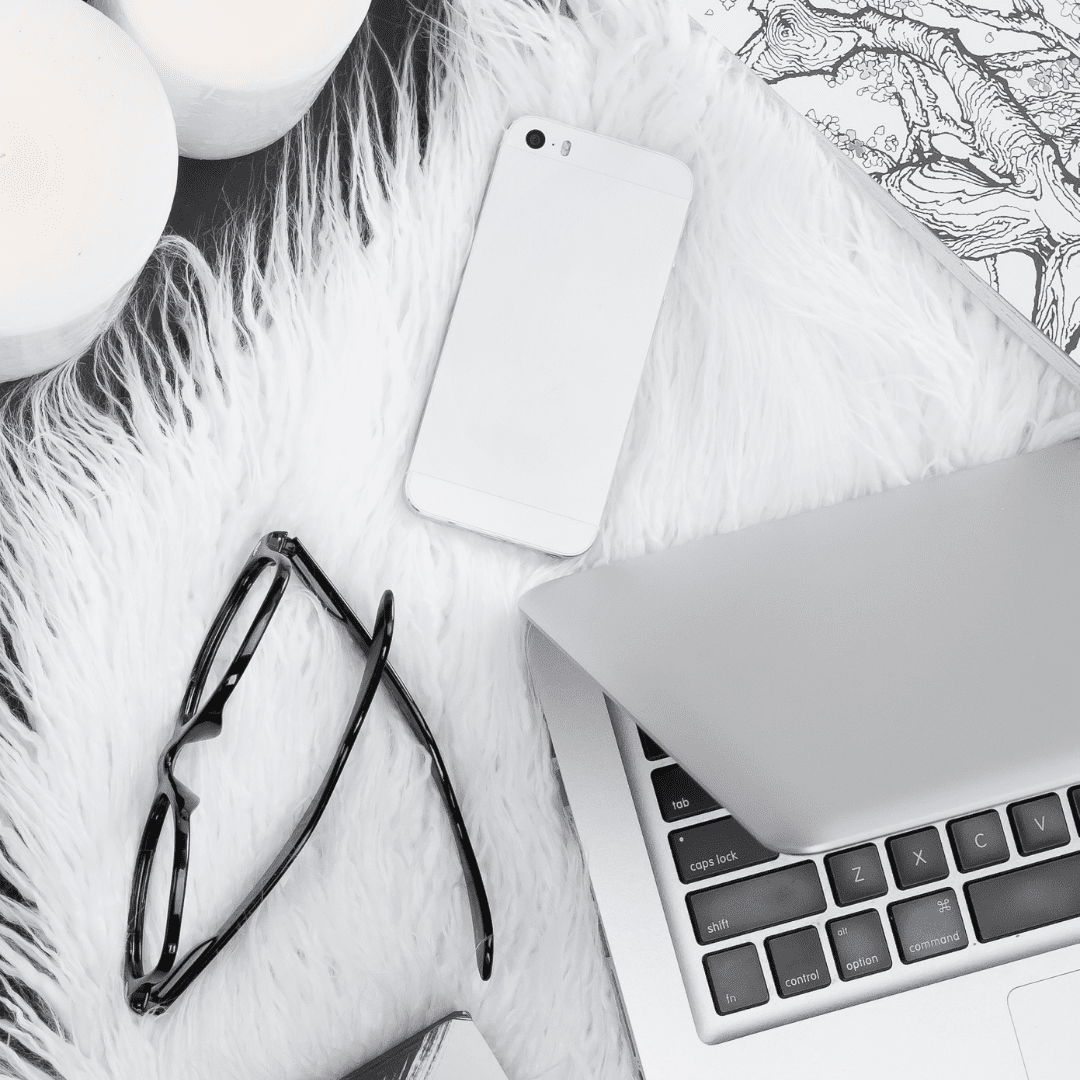 macbook and fuzzy blanket, laptop on bed