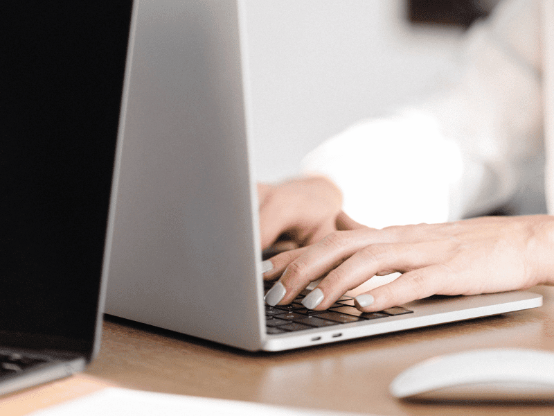 woman typing on a laptop