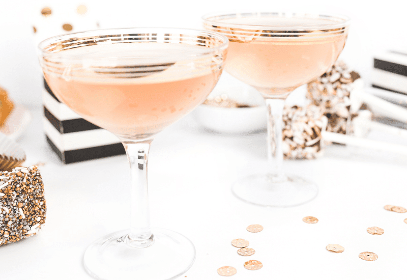 Two champagne glasses set for the Motivational Monday Series – ‘Tis the Season to Sparkle