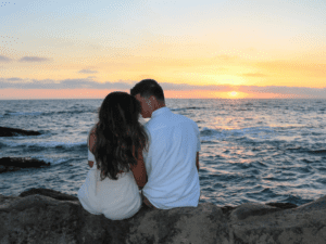 How to Have the Best Valentine’s Day on the Crystal Coast, Couple watching the sunset on the beach
