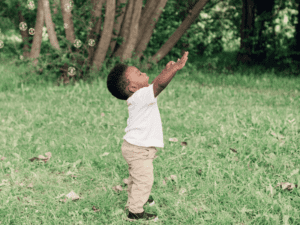 Baby playingwith bubbles outside